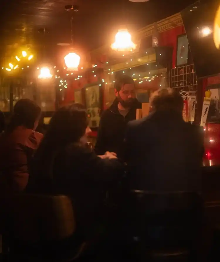 Guests sharing a quiet conversation at the bar